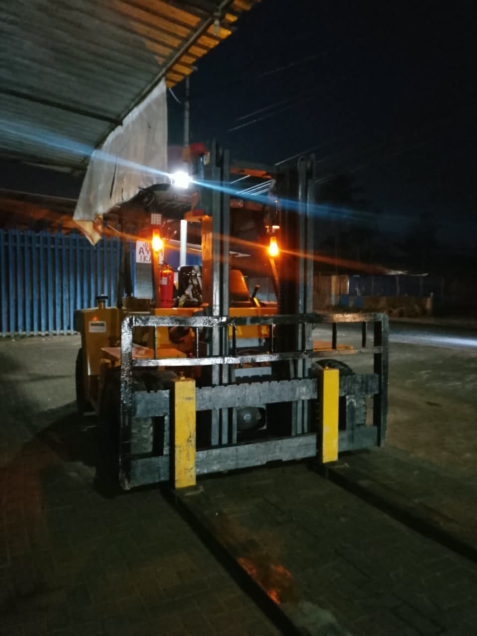 Forklift beroperasi pada malam hari untuk memindahkan muatan